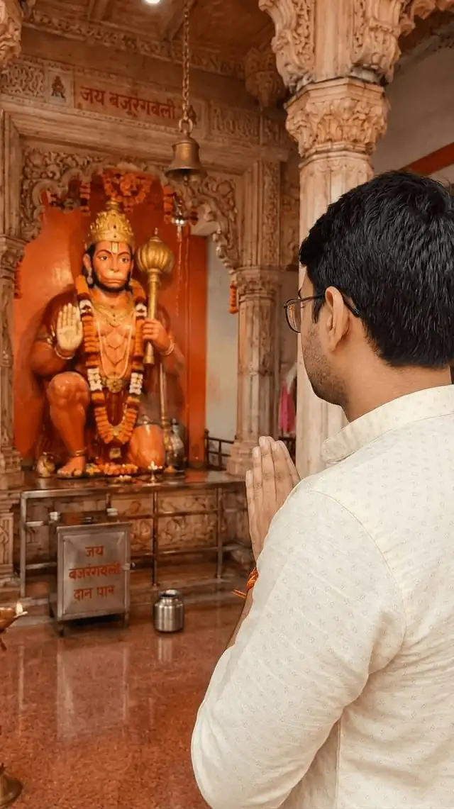 Saurabh Satyaram with folded hands at darshan of Hanuman ji in a mandir